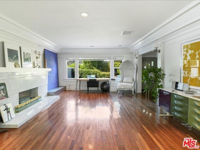 unfurnished room featuring crown molding, dark wood-type flooring, and a high end fireplace