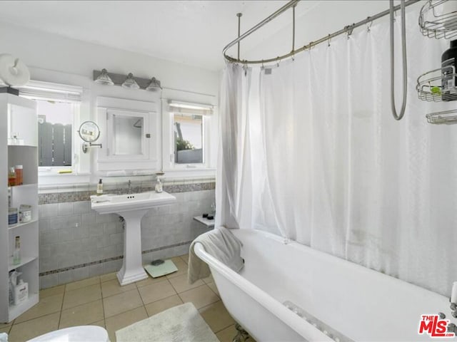 bathroom with tile walls and tile patterned floors