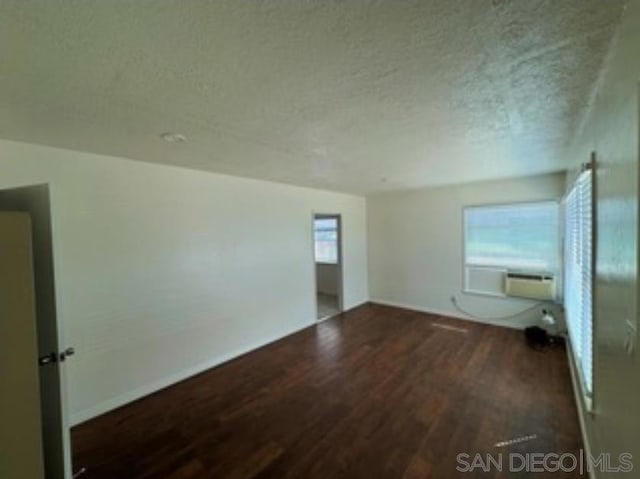 unfurnished room featuring dark hardwood / wood-style flooring