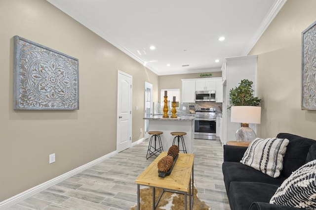 living room with ornamental molding and light wood-type flooring