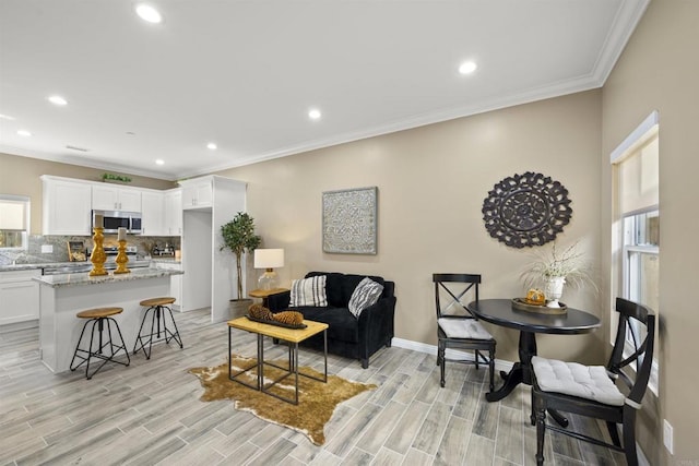 living room with ornamental molding and light wood-type flooring