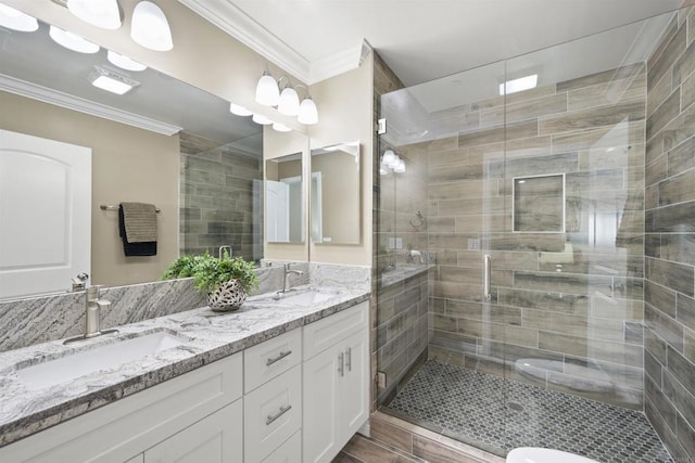 bathroom featuring vanity, crown molding, and an enclosed shower