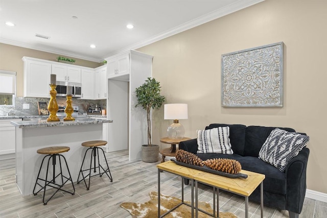 living room with ornamental molding