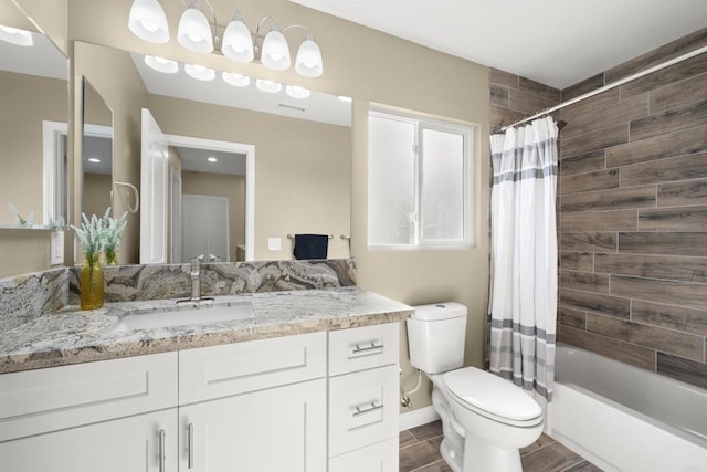 full bathroom with toilet, vanity, and shower / tub combo with curtain