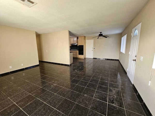 spare room featuring ceiling fan and a textured ceiling