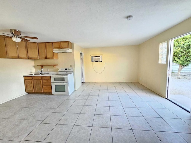 kitchen with light tile patterned floors, ceiling fan, a wall mounted air conditioner, a textured ceiling, and white range with electric cooktop