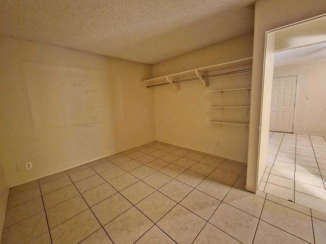 spacious closet with light tile patterned floors