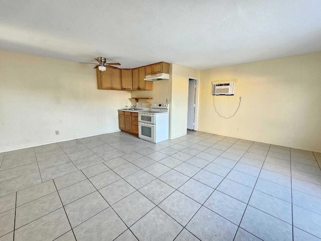 kitchen with ceiling fan, a wall mounted AC, sink, white electric stove, and light tile patterned floors