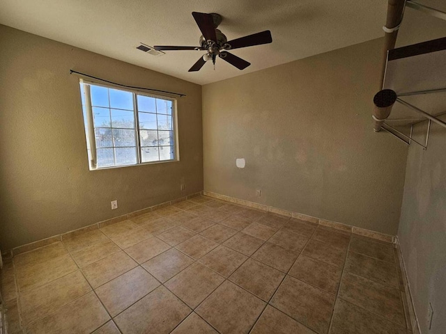 spare room featuring ceiling fan and light tile patterned flooring