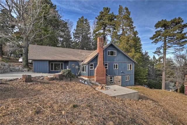 view of front of home with a chimney and a patio