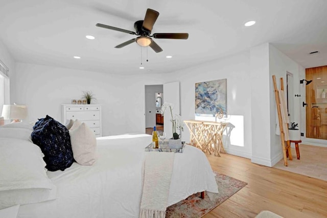 bedroom with ceiling fan and light hardwood / wood-style flooring