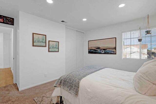 bedroom featuring light carpet