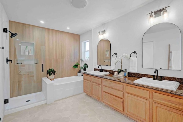 bathroom with tile patterned flooring, vanity, and shower with separate bathtub