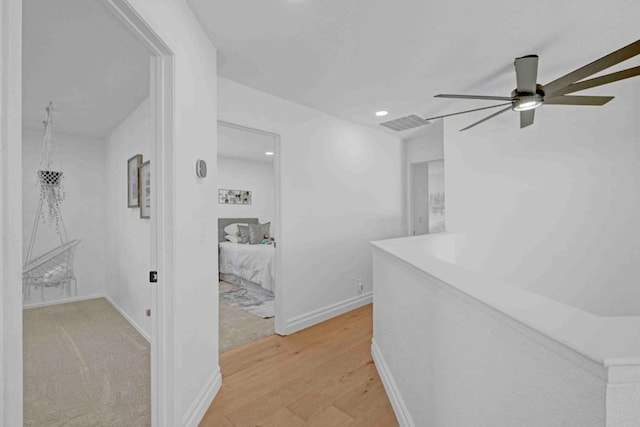 hallway with light hardwood / wood-style flooring