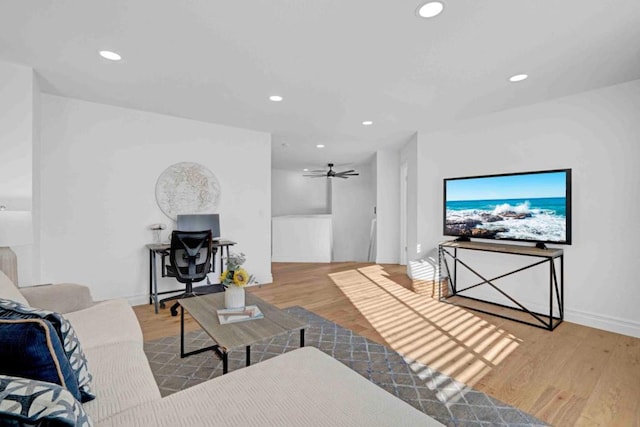 living room featuring ceiling fan and light wood-type flooring