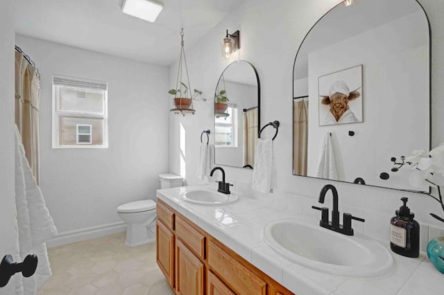 bathroom featuring toilet and vanity