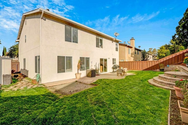 back of property featuring a lawn, central AC, and a patio area