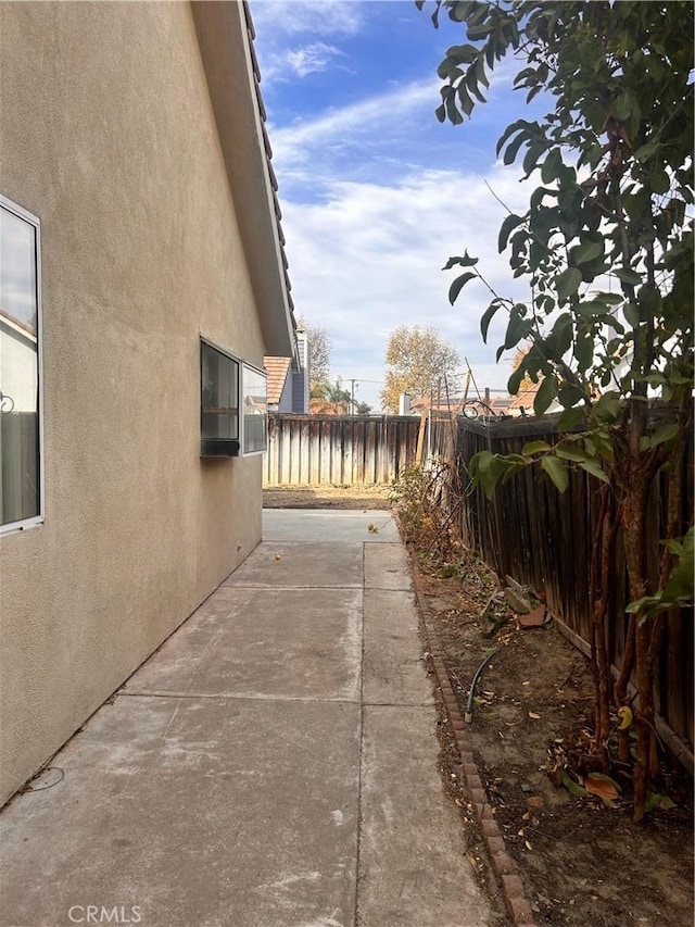 view of side of home with a patio area