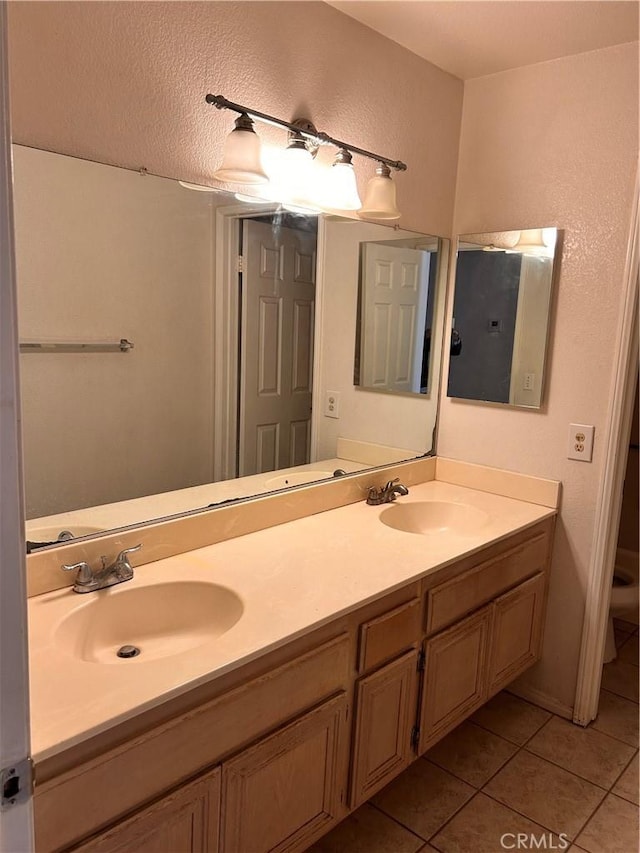 bathroom with tile patterned floors, vanity, and toilet