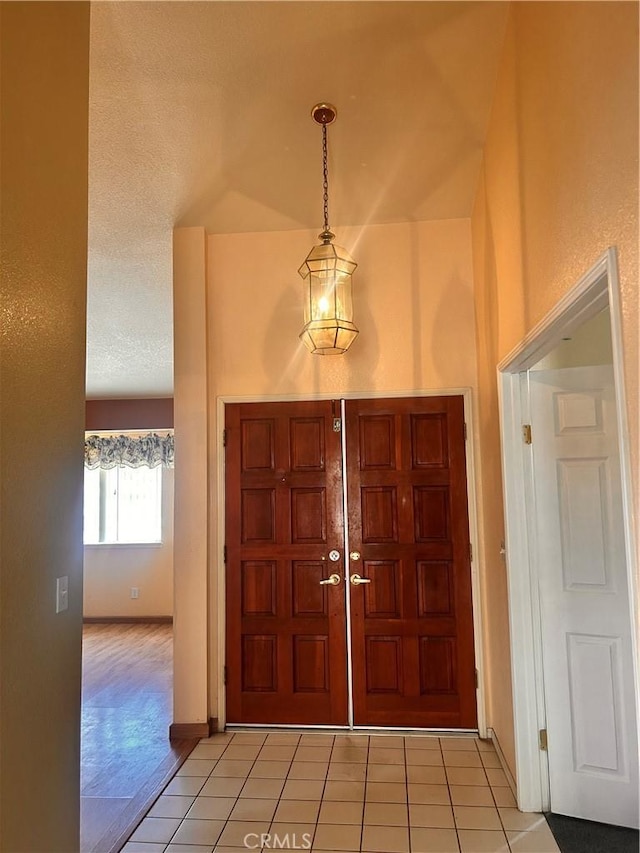 foyer entrance featuring light tile patterned floors