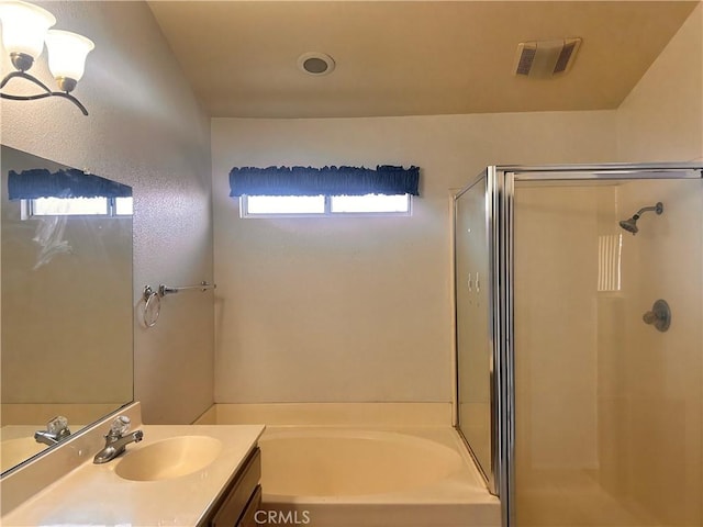 bathroom with vanity and separate shower and tub