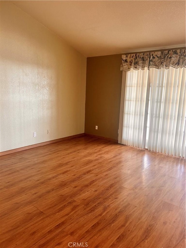 spare room with hardwood / wood-style floors