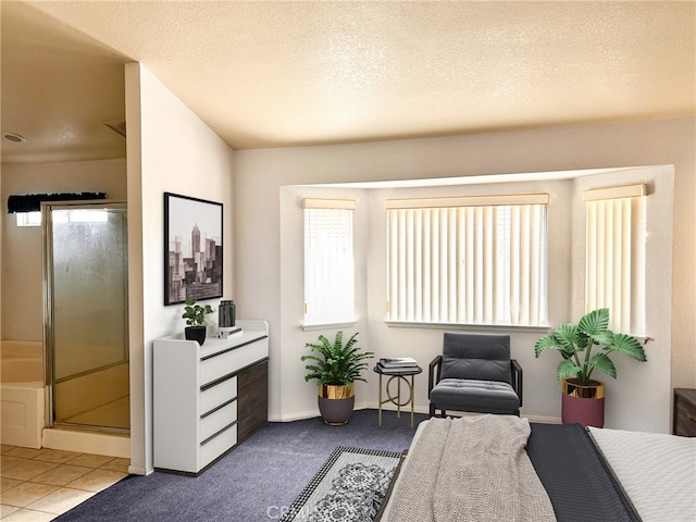 tiled bedroom featuring a textured ceiling