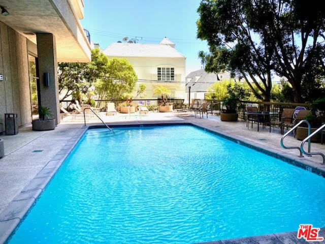 view of swimming pool with a patio