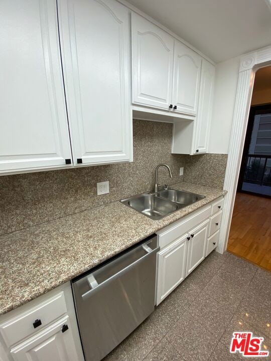 kitchen with decorative backsplash, dishwasher, white cabinets, and sink