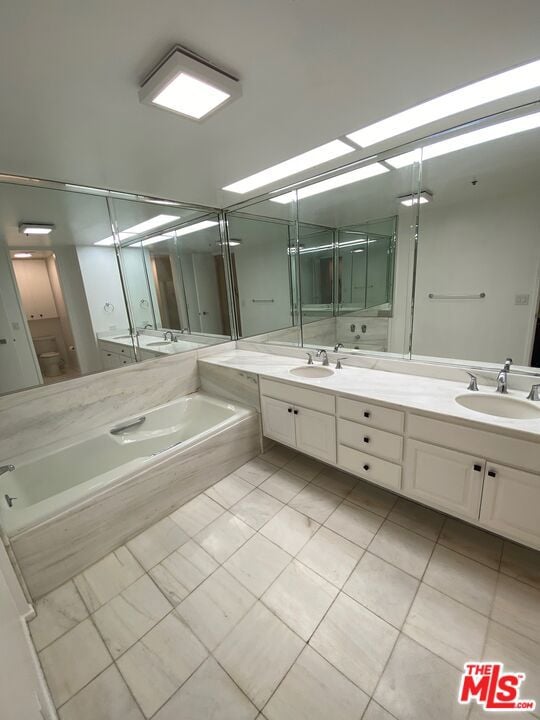 bathroom with vanity, tile patterned floors, and shower with separate bathtub