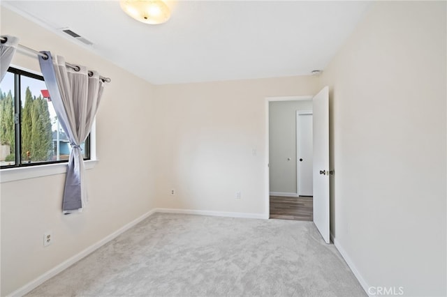 empty room featuring light colored carpet