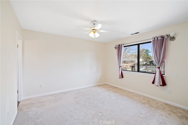 carpeted spare room with ceiling fan