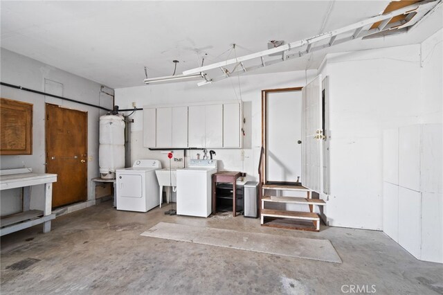 garage with washer and clothes dryer and sink