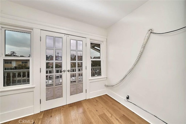 doorway to outside featuring french doors and wood finished floors