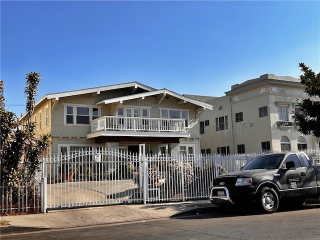 view of front of home featuring a fenced front yard and a balcony