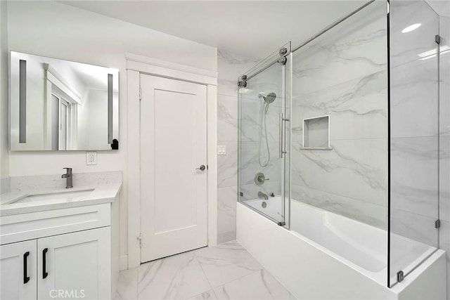 bathroom featuring marble finish floor, enclosed tub / shower combo, and vanity