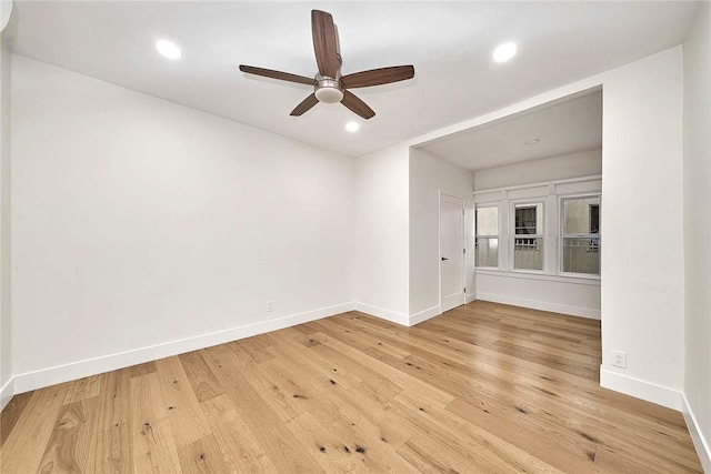 spare room featuring light wood-style flooring, baseboards, a ceiling fan, and recessed lighting