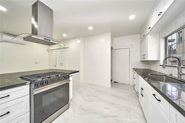 kitchen featuring island range hood, white cabinets, gas range, marble finish floor, and a sink