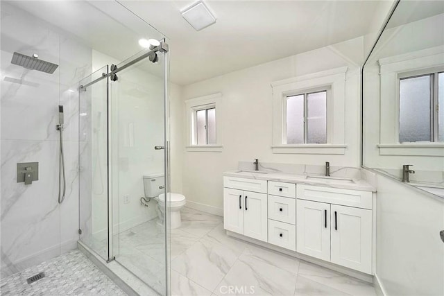 bathroom with marble finish floor, double vanity, a sink, and a marble finish shower