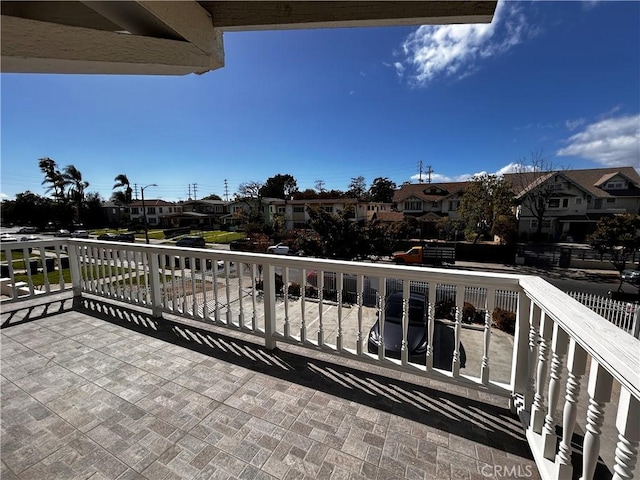 view of patio with a residential view and a balcony