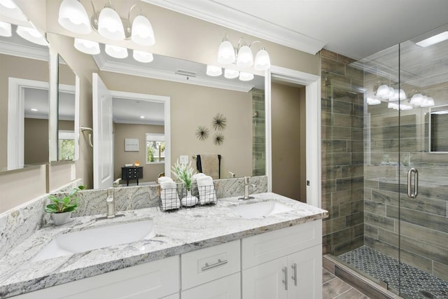 bathroom with an enclosed shower, vanity, and ornamental molding