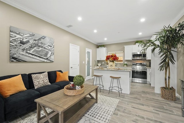 living room featuring crown molding and light hardwood / wood-style floors