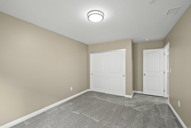 unfurnished bedroom featuring a closet and carpet floors