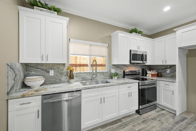 kitchen featuring appliances with stainless steel finishes, sink, and white cabinetry