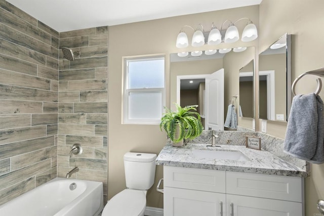 full bathroom with toilet, tiled shower / bath combo, and vanity