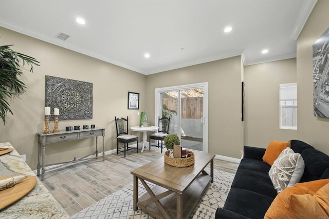 living room with light hardwood / wood-style flooring and ornamental molding