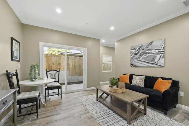 living room featuring crown molding and light hardwood / wood-style floors