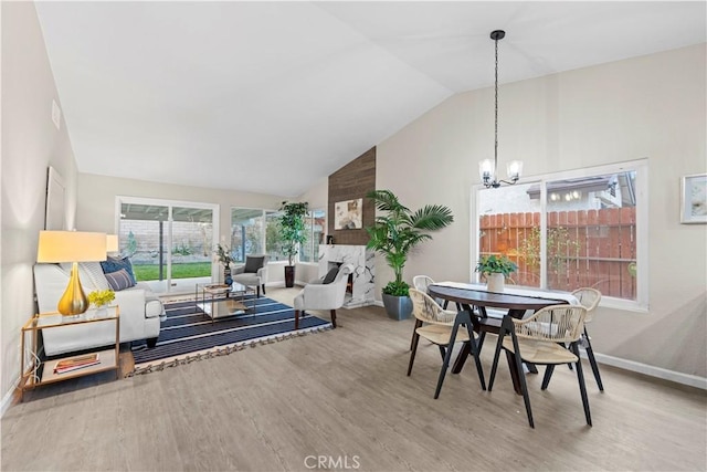 interior space with an inviting chandelier, lofted ceiling, and hardwood / wood-style floors