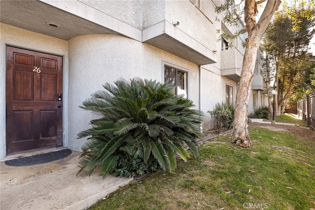 doorway to property featuring a yard