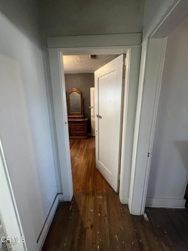 corridor featuring dark hardwood / wood-style floors